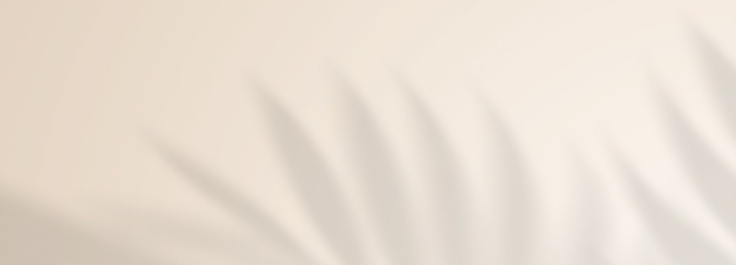 A minimalist background image with a solid light beige color on the top half and soft, blurred shadows of what appear to be wavy or pleated fabric on the bottom half.
